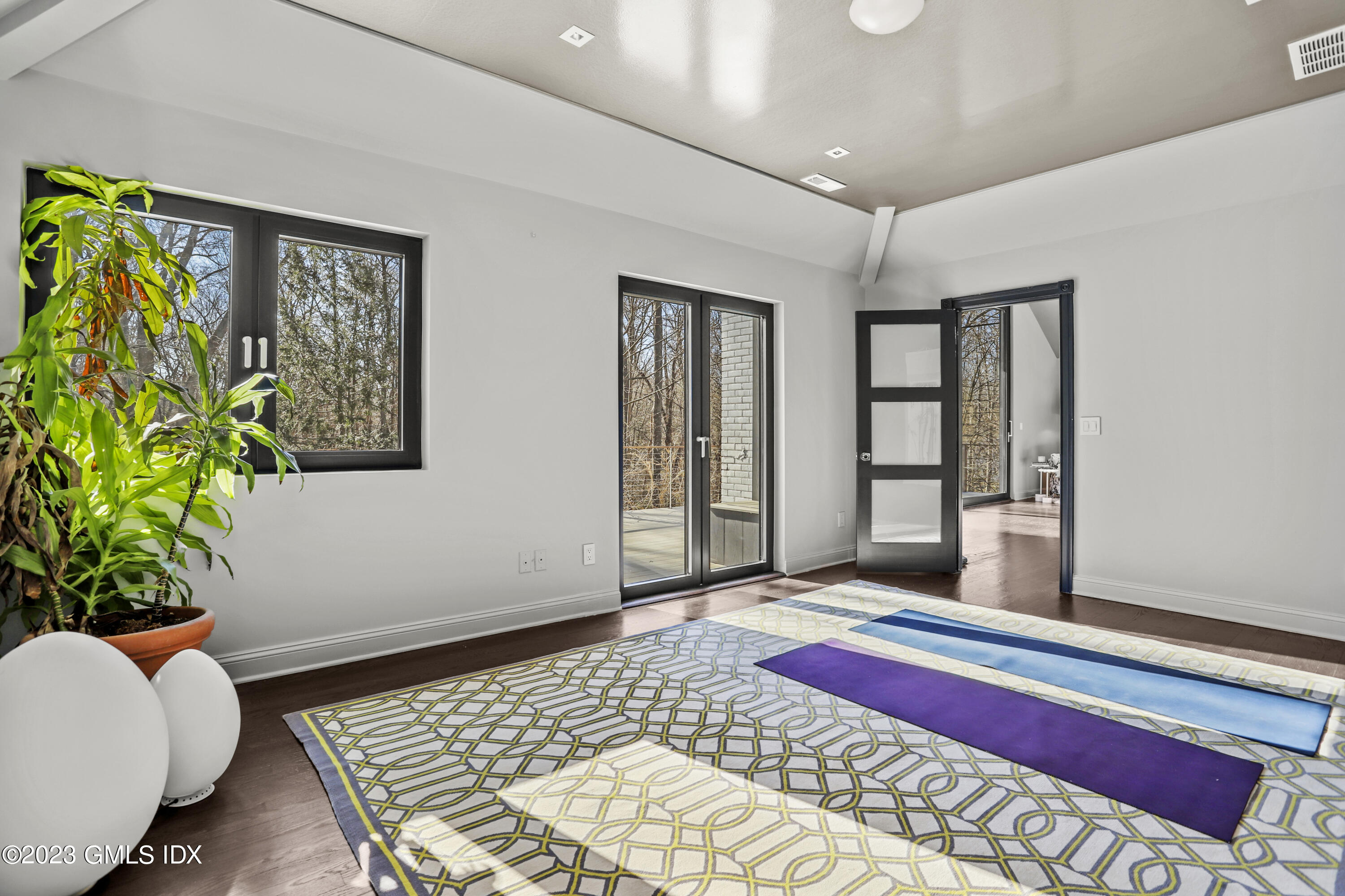 56 Dingletown Road Greenwich, CT 06830 - Photo 26 of 38 a bedroom with furniture and a potted plant