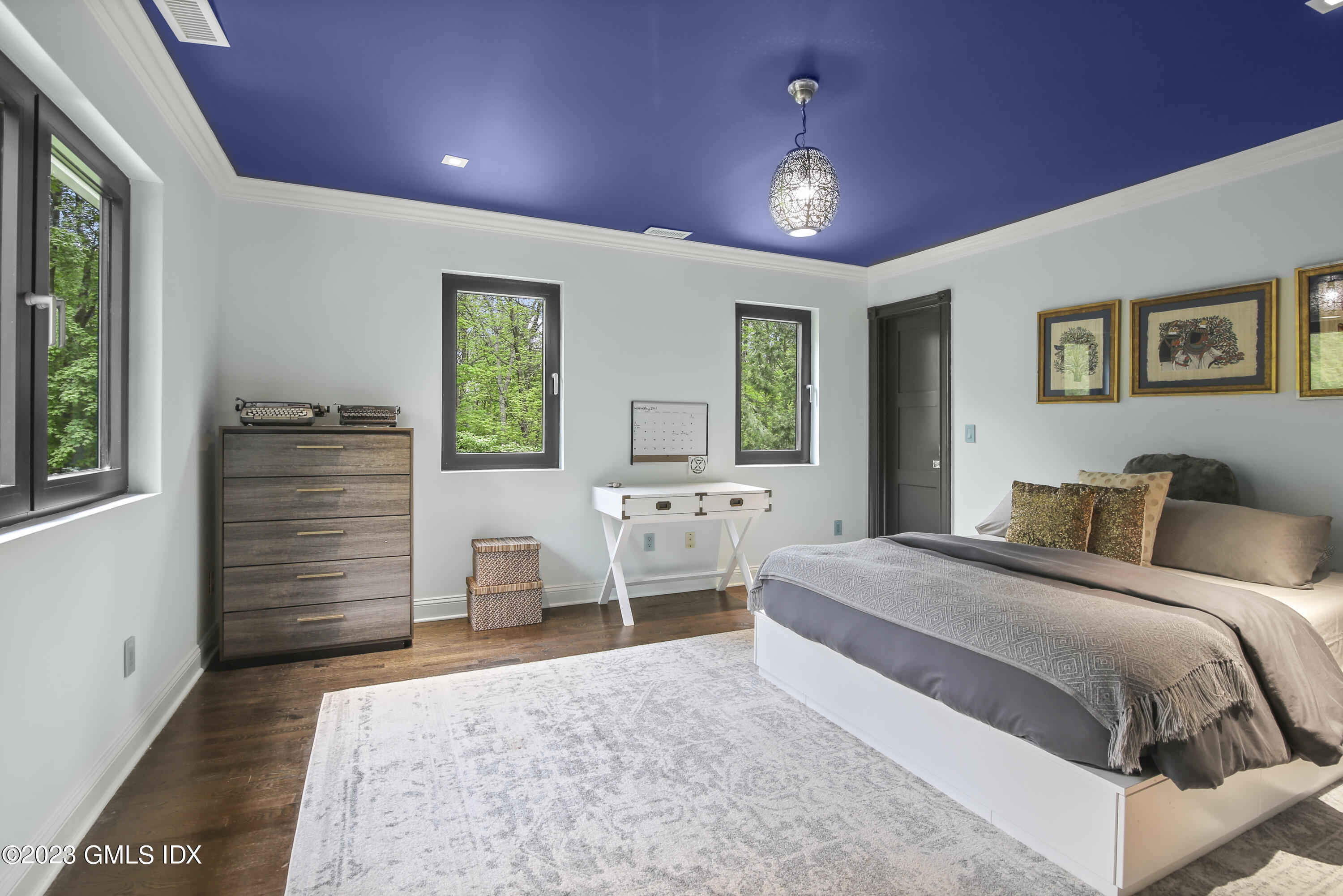 56 Dingletown Road Greenwich, CT 06830 - Photo 31 of 38 a bedroom with a bed and a chandelier