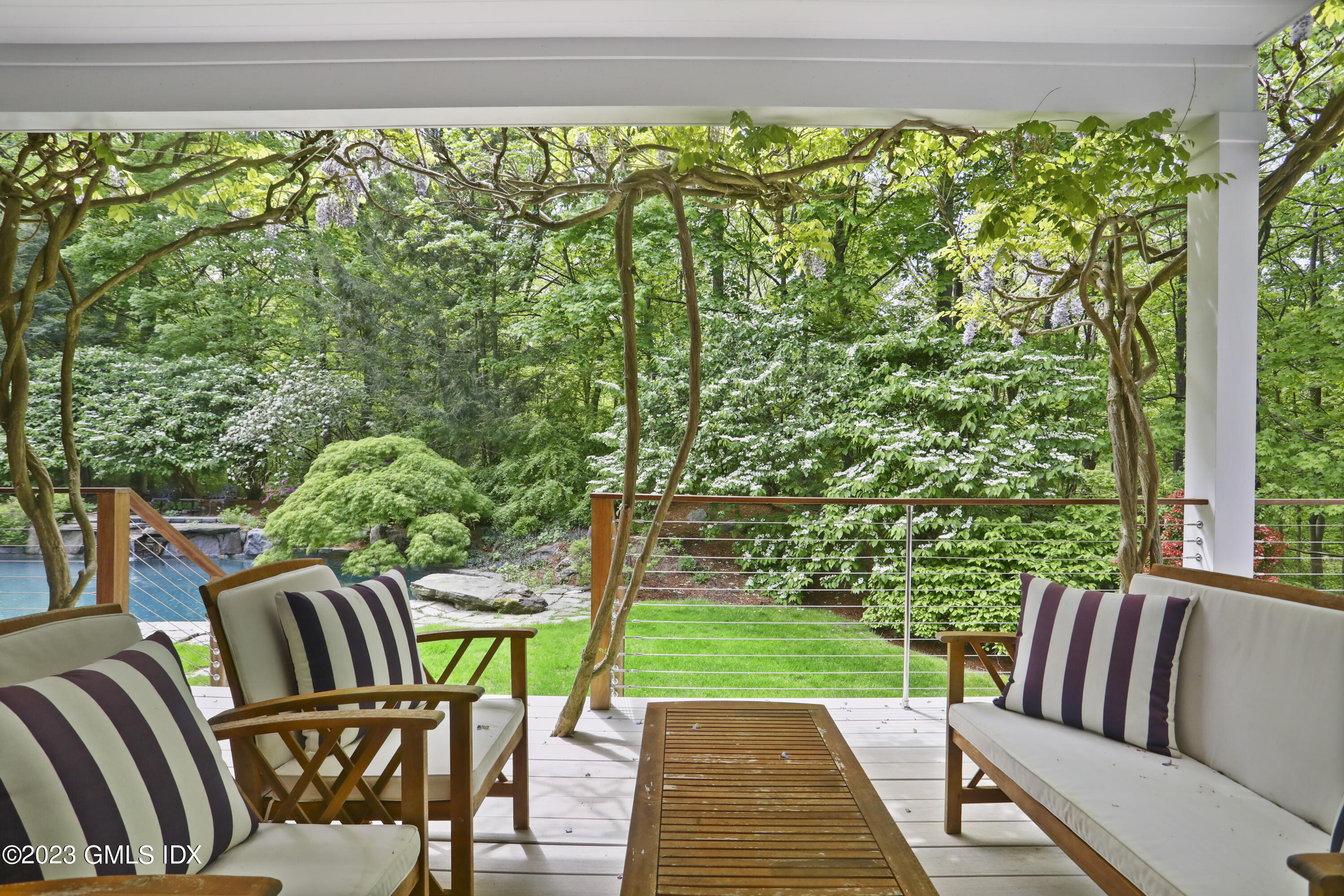 56 Dingletown Road Greenwich, CT 06830 - Photo 8 of 38 a view of a two chairs in patio with a small yard