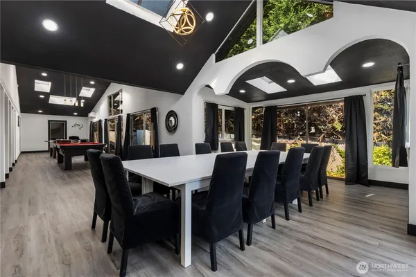 a view of a living room and kitchen with furniture wooden floor and windows