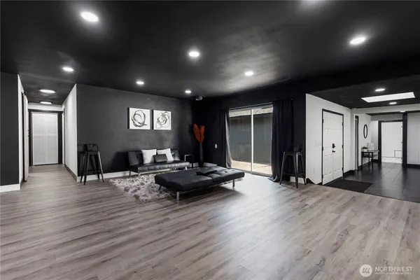 a living room with furniture and a wooden floor