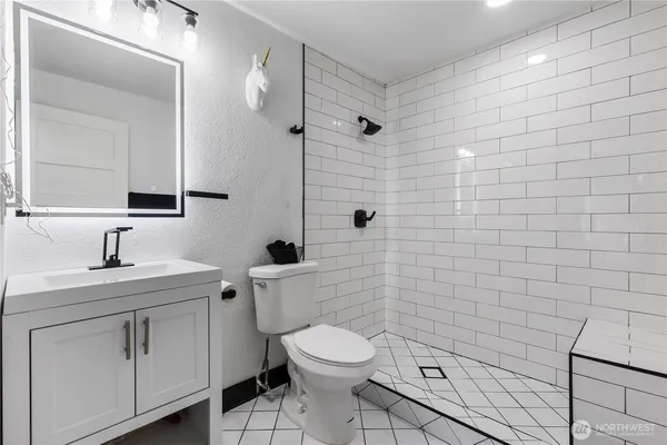 a bathroom with a toilet and a shower