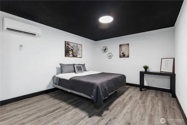 a bedroom with a bed and wooden floor