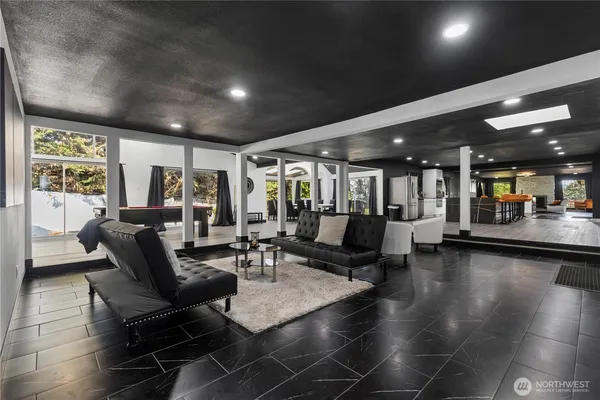 a living room with furniture and a hard wood floor