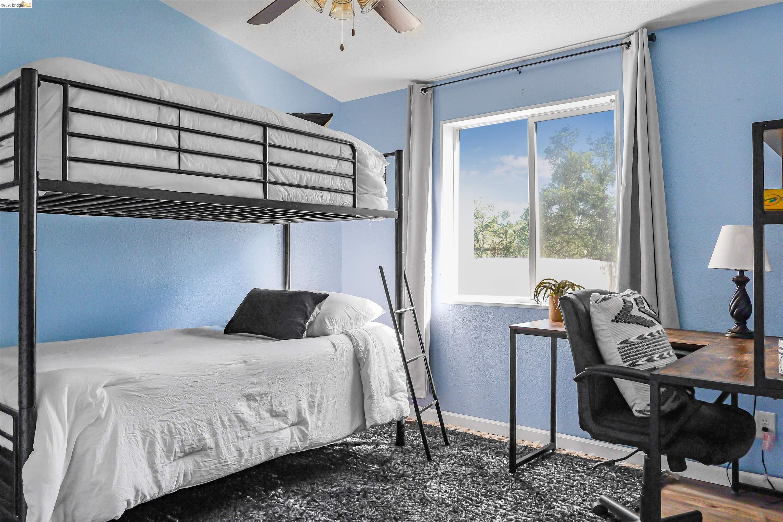 4419 Little John Road Copperopolis, CA 95228 - Photo 16 of 43 Bedroom featuring a bright window with exterior landscaping, blue painted walls, and a ceiling fan