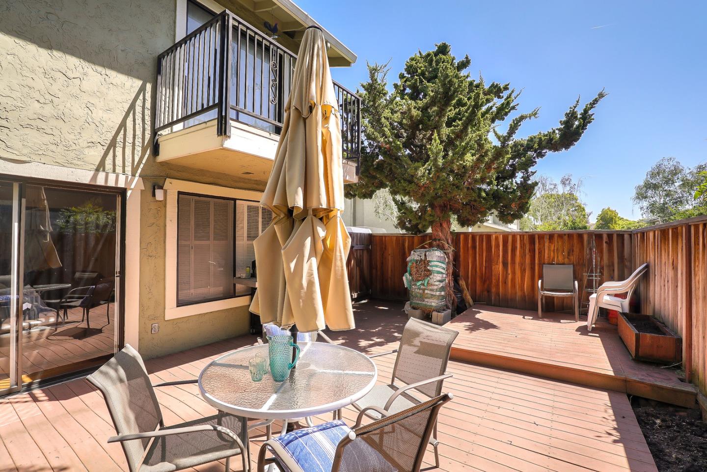 3744 Adriatic Way Santa Clara, CA 95051 - Photo 32 of 34 a view of a patio with table and chairs with wooden floor and fence