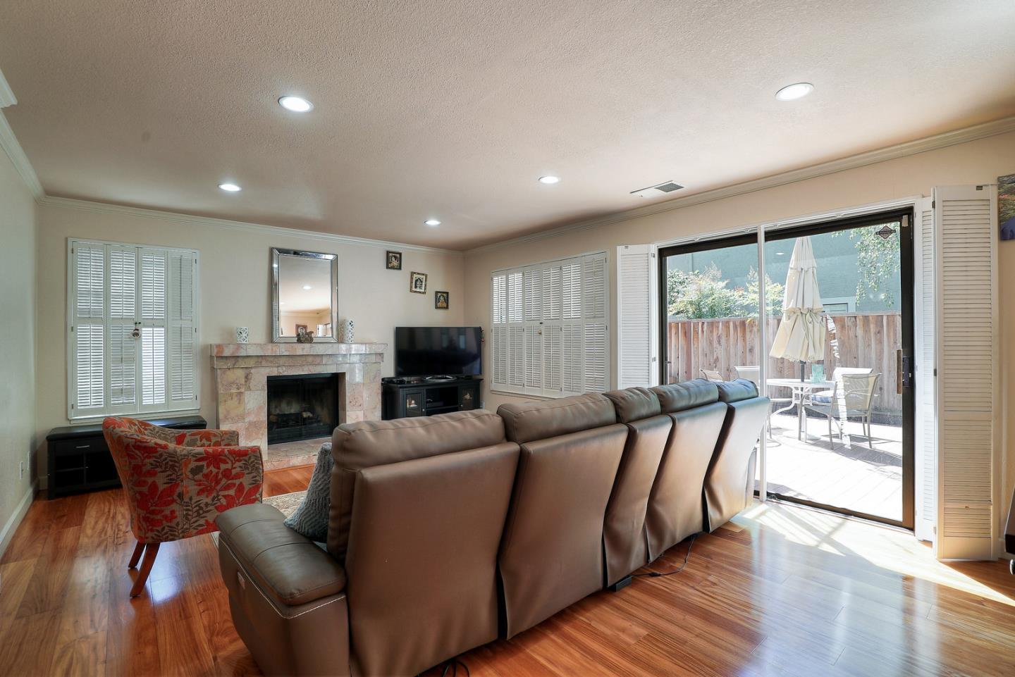 3744 Adriatic Way Santa Clara, CA 95051 - Photo 5 of 34 a living room with furniture a fireplace and a floor to ceiling window