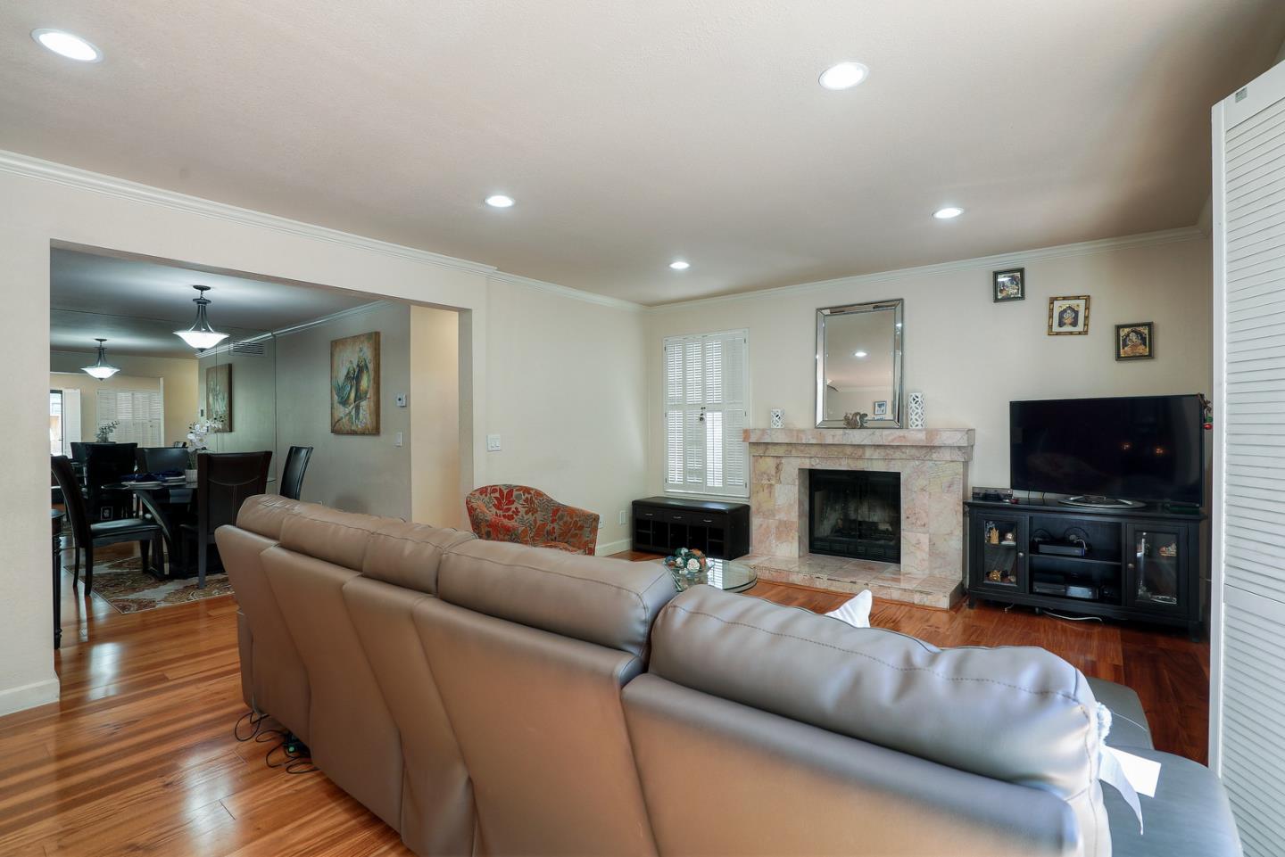 3744 Adriatic Way Santa Clara, CA 95051 - Photo 6 of 34 a living room with furniture a fireplace and a flat screen tv