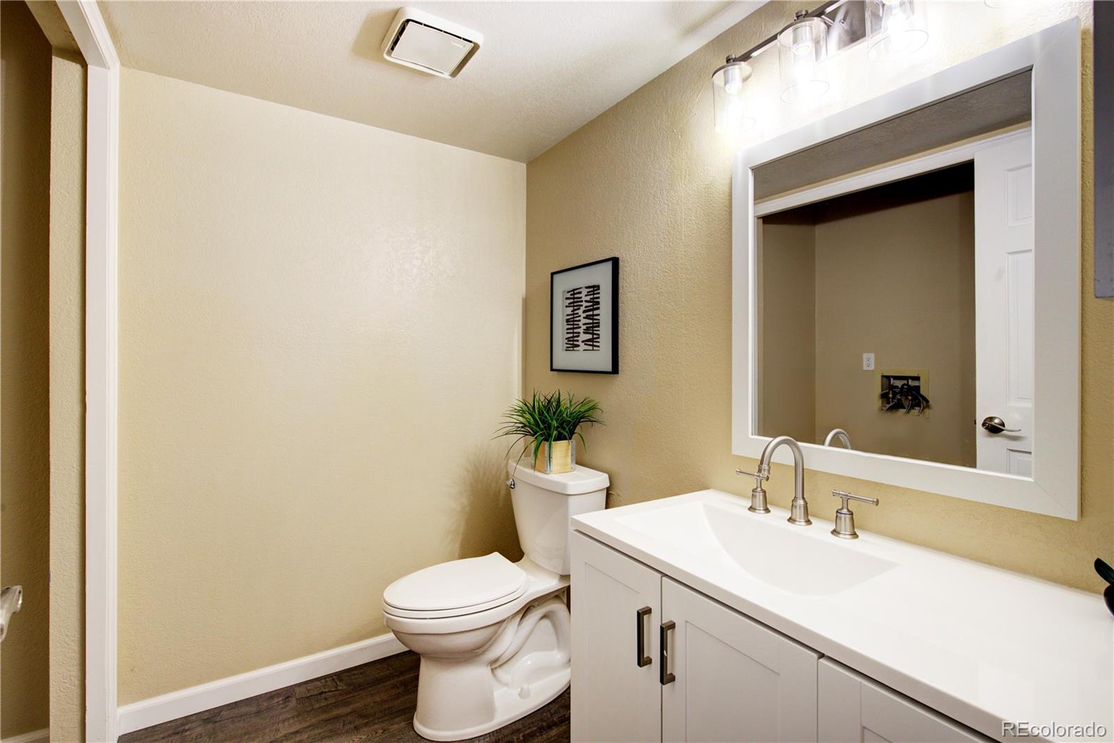2138 Ranch Drive Westminster, CO 80234 - Photo 13 of 31 a bathroom with a sink a toilet and mirror