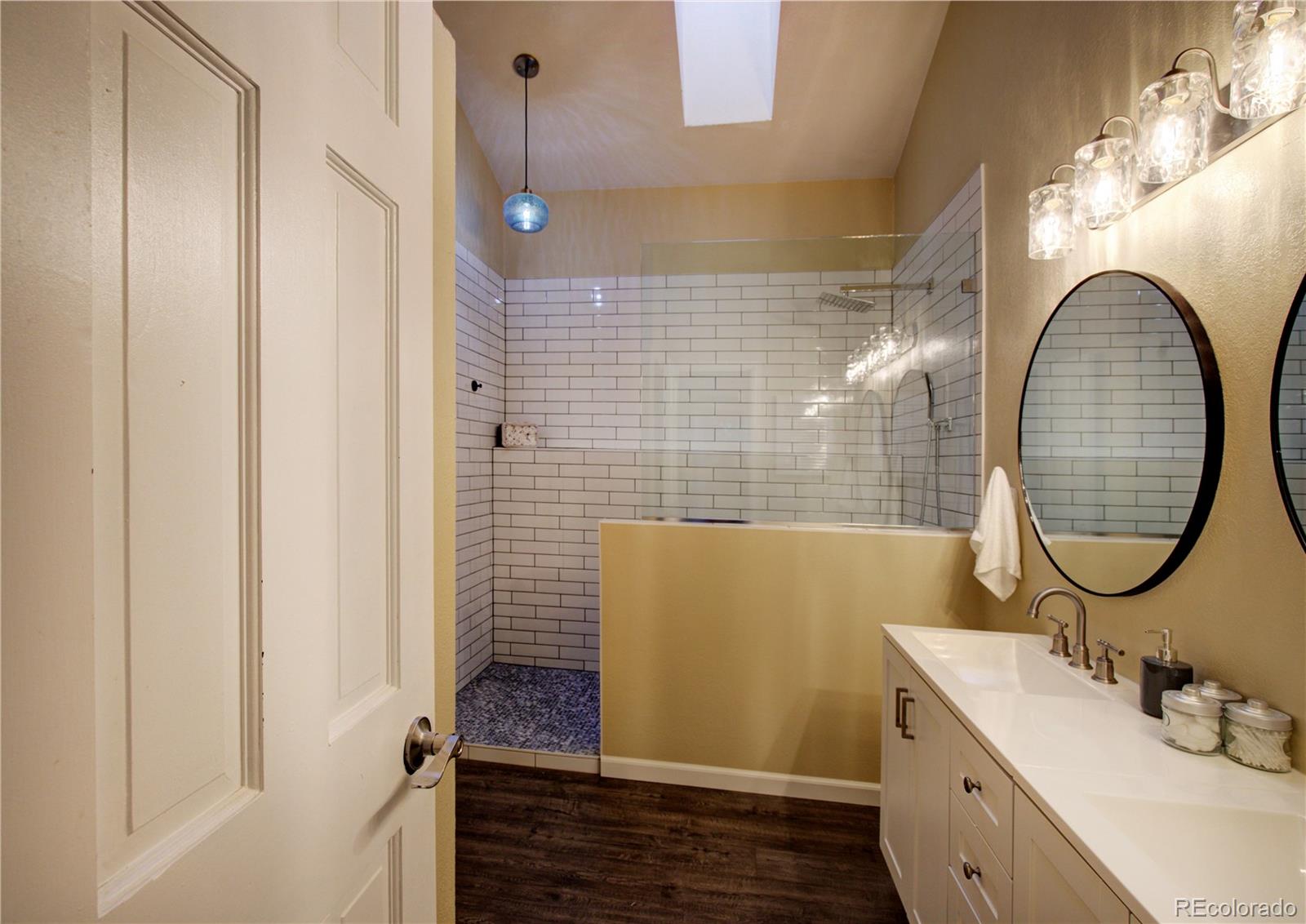 2138 Ranch Drive Westminster, CO 80234 - Photo 18 of 31 a bathroom with a sink mirror and tub