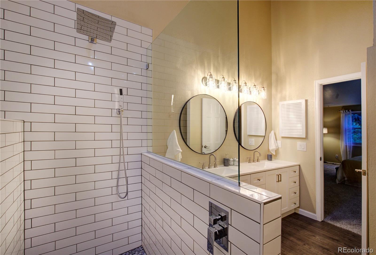 2138 Ranch Drive Westminster, CO 80234 - Photo 20 of 31 a bathroom with a sink mirror vanity and toilet