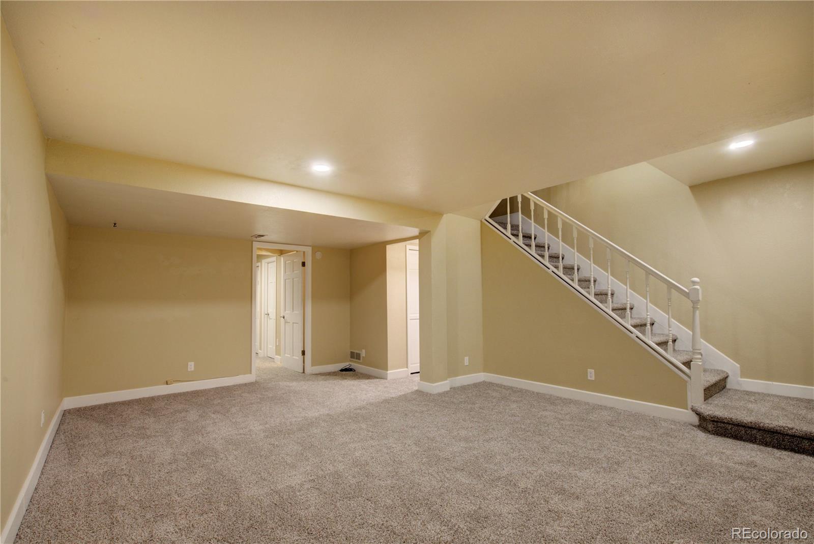 2138 Ranch Drive Westminster, CO 80234 - Photo 24 of 31 a view of an empty room with stairs