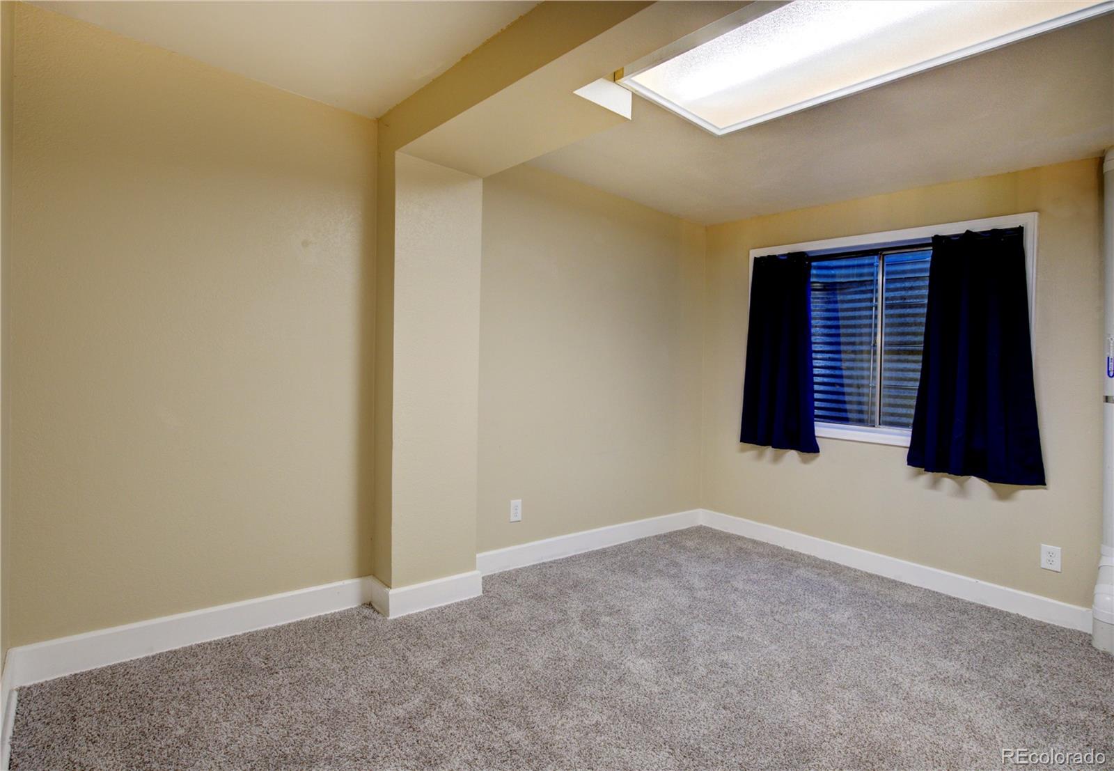 2138 Ranch Drive Westminster, CO 80234 - Photo 26 of 31 a view of an empty room with wooden floor