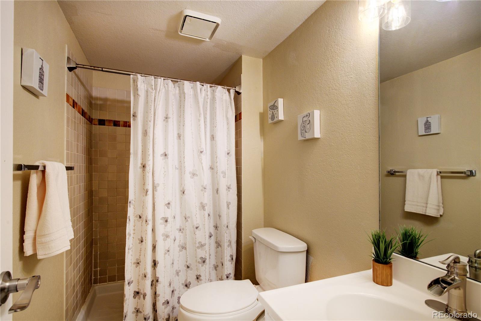 2138 Ranch Drive Westminster, CO 80234 - Photo 28 of 31 a bathroom with a sink toilet and shower