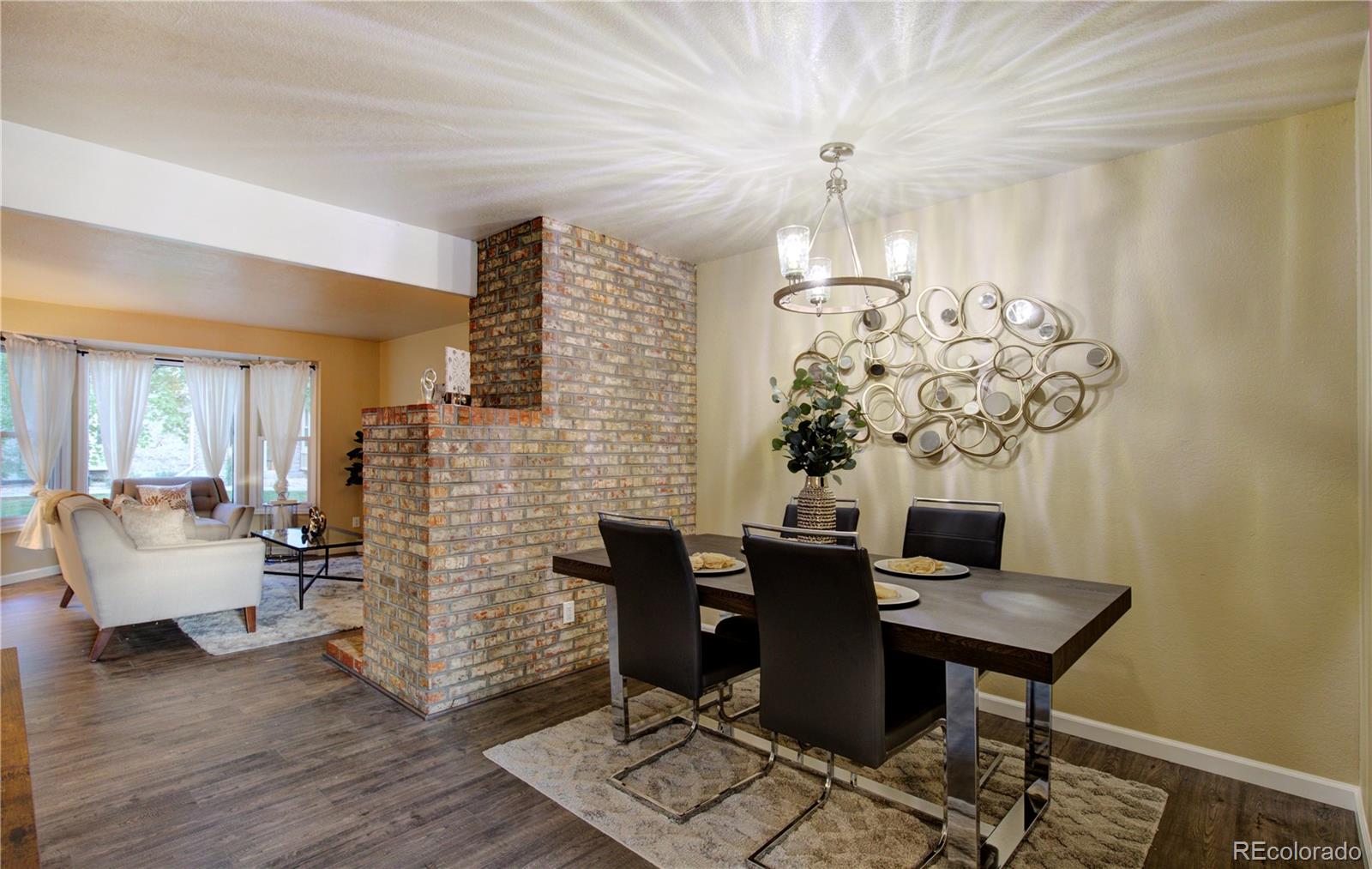 2138 Ranch Drive Westminster, CO 80234 - Photo 8 of 31 a view of a dining room with furniture wooden floor and chandelier