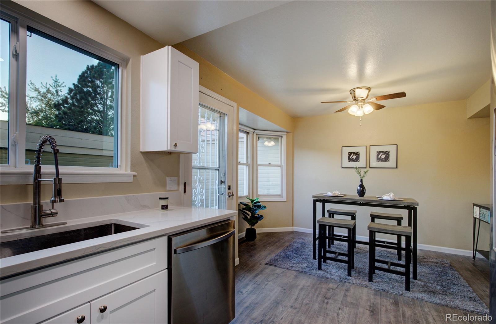 2138 Ranch Drive Westminster, CO 80234 - Photo 10 of 31 a kitchen with a table chairs sink and cabinets