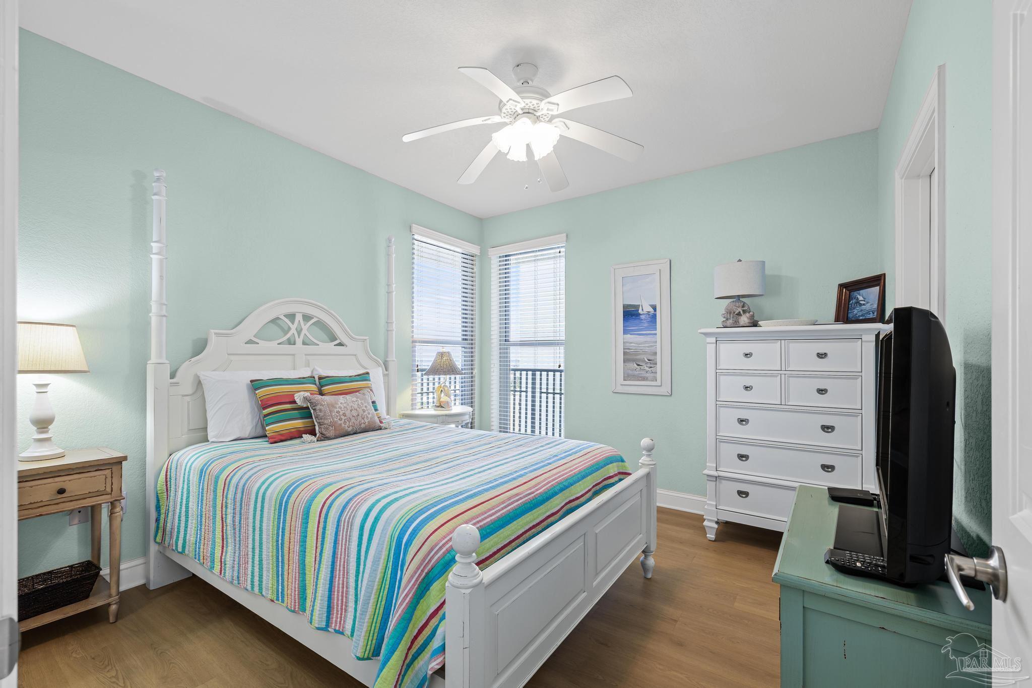 850 Fort Pickens Road, Unit 1230 Pensacola Beach, FL 32561 - Photo 12 of 67 a bedroom with a bed and a chandelier