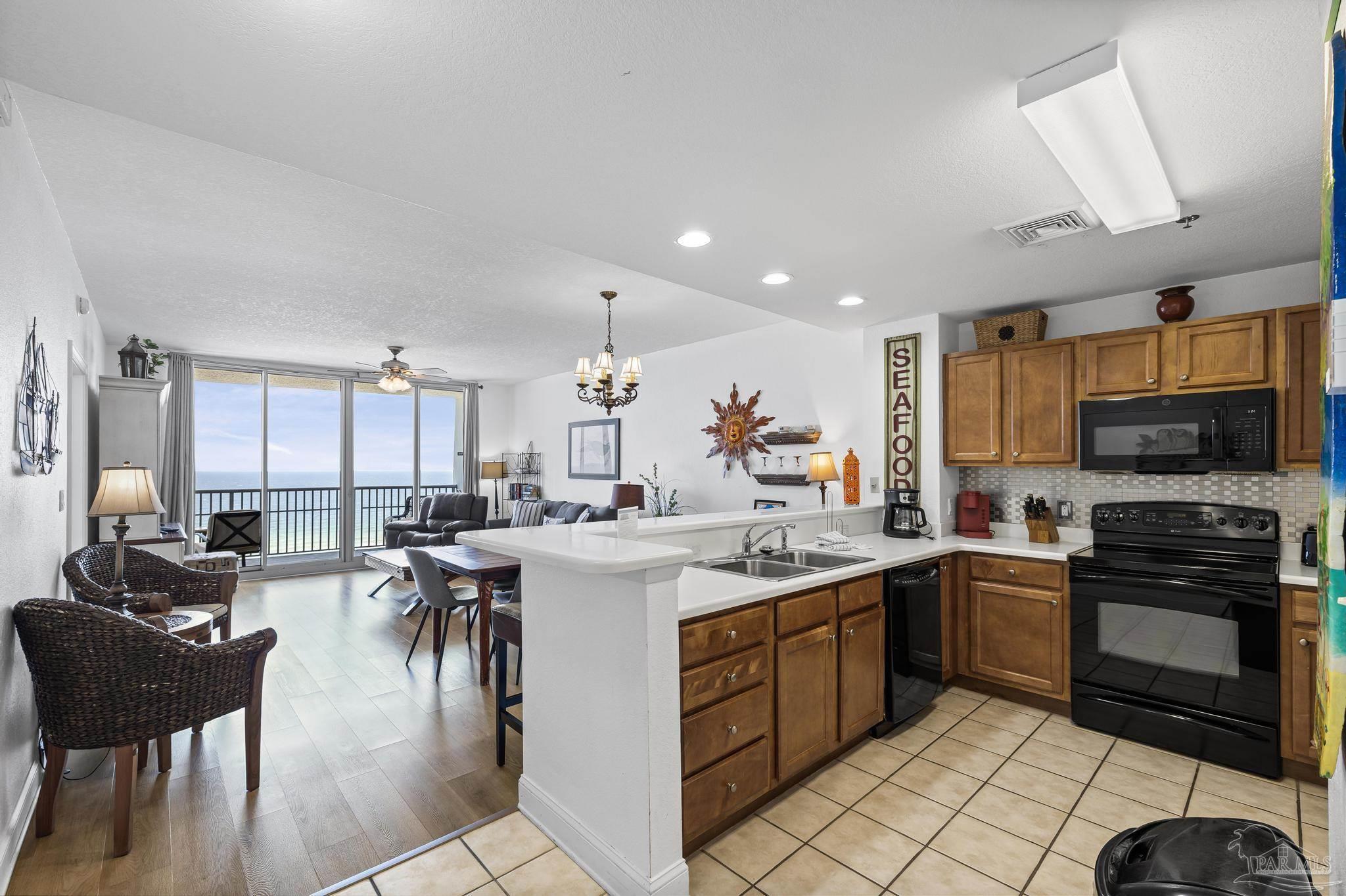850 Fort Pickens Road, Unit 1230 Pensacola Beach, FL 32561 - Photo 15 of 67 a kitchen with lots of counter top space and appliances