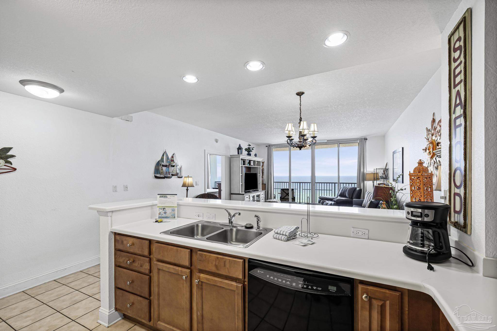 850 Fort Pickens Road, Unit 1230 Pensacola Beach, FL 32561 - Photo 19 of 67 a kitchen with a sink appliances and cabinets
