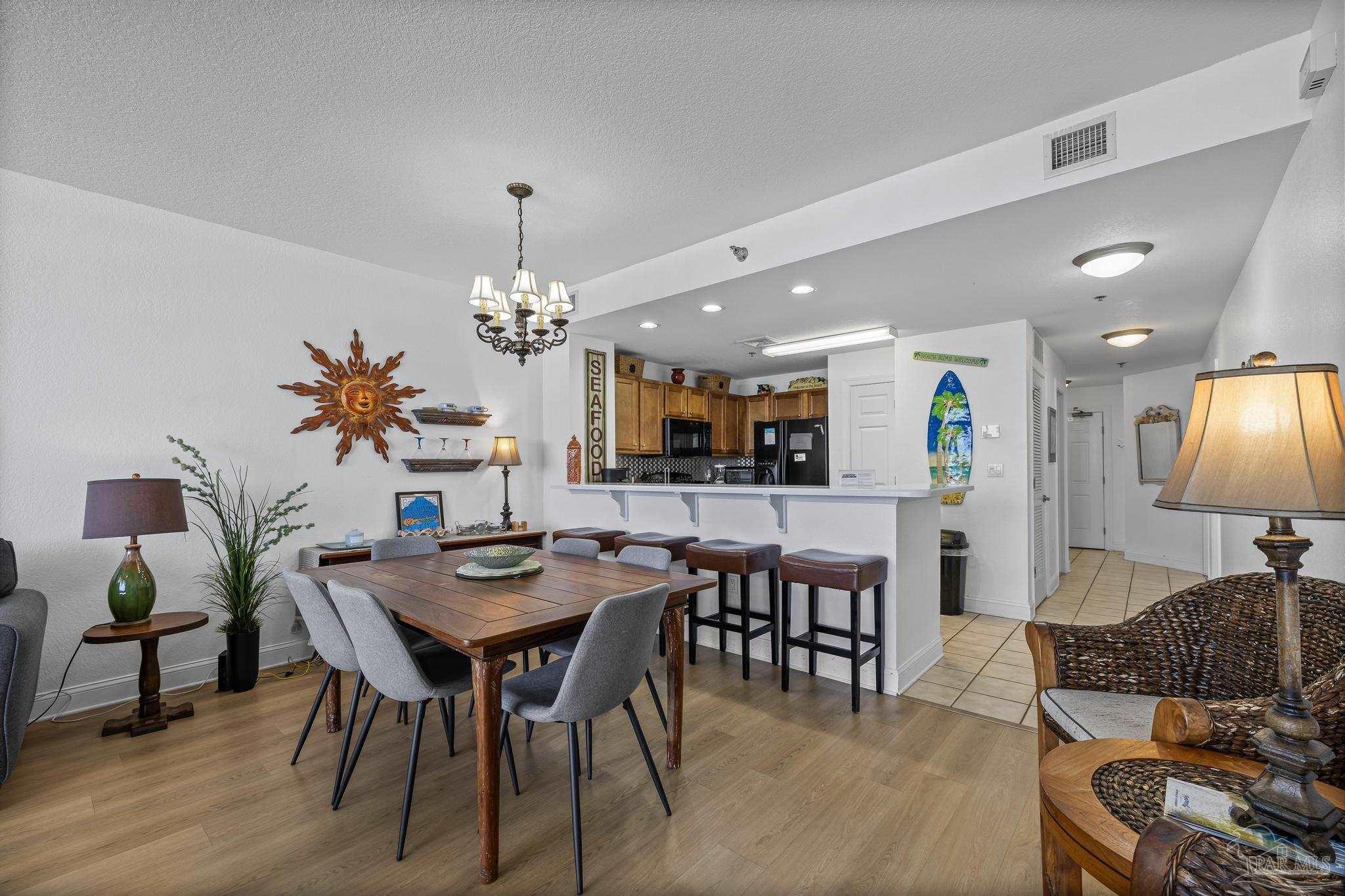 850 Fort Pickens Road, Unit 1230 Pensacola Beach, FL 32561 - Photo 22 of 67 a view of a dining room with furniture and wooden floor
