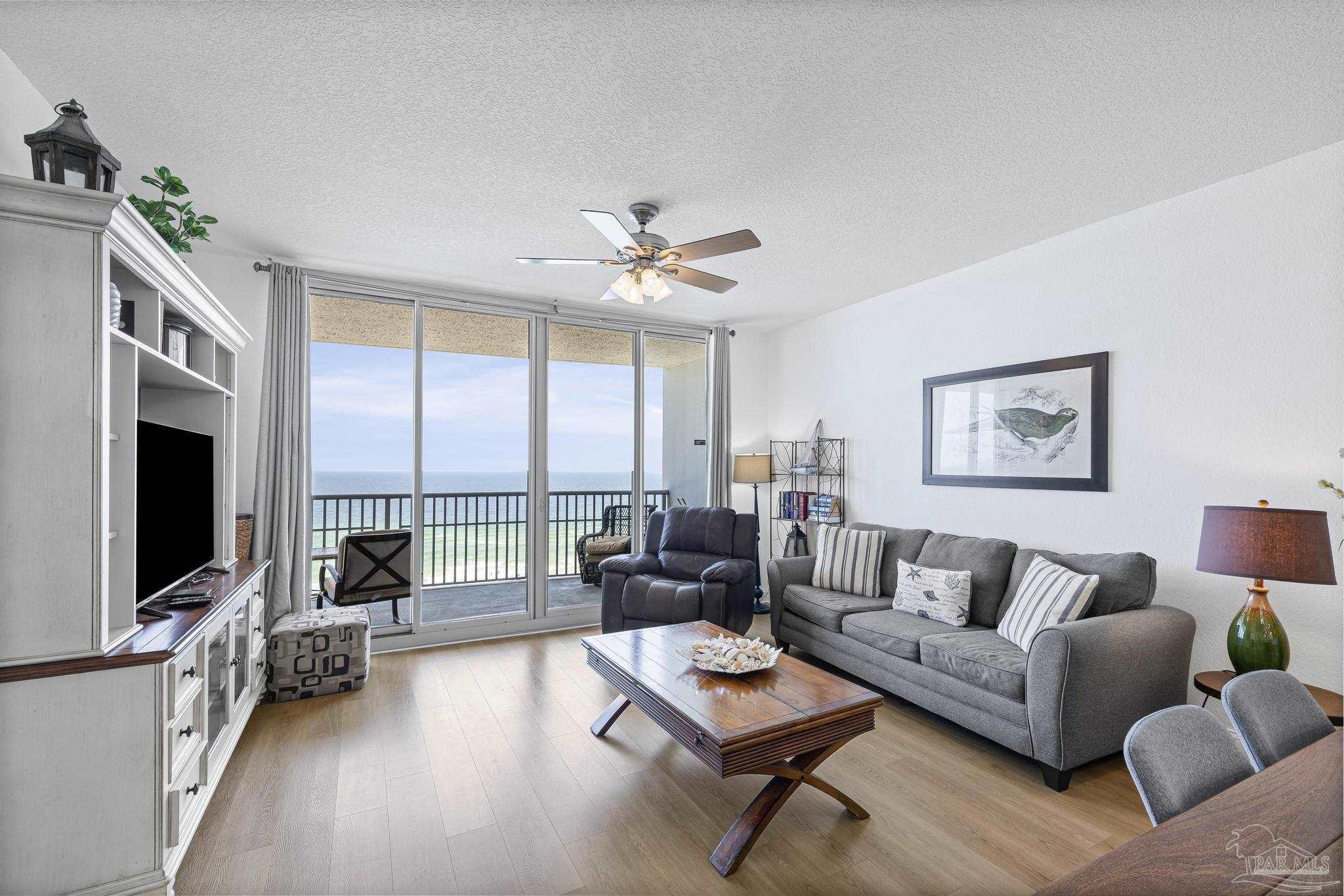 850 Fort Pickens Road, Unit 1230 Pensacola Beach, FL 32561 - Photo 23 of 67 a living room with furniture a flat screen tv and a large window