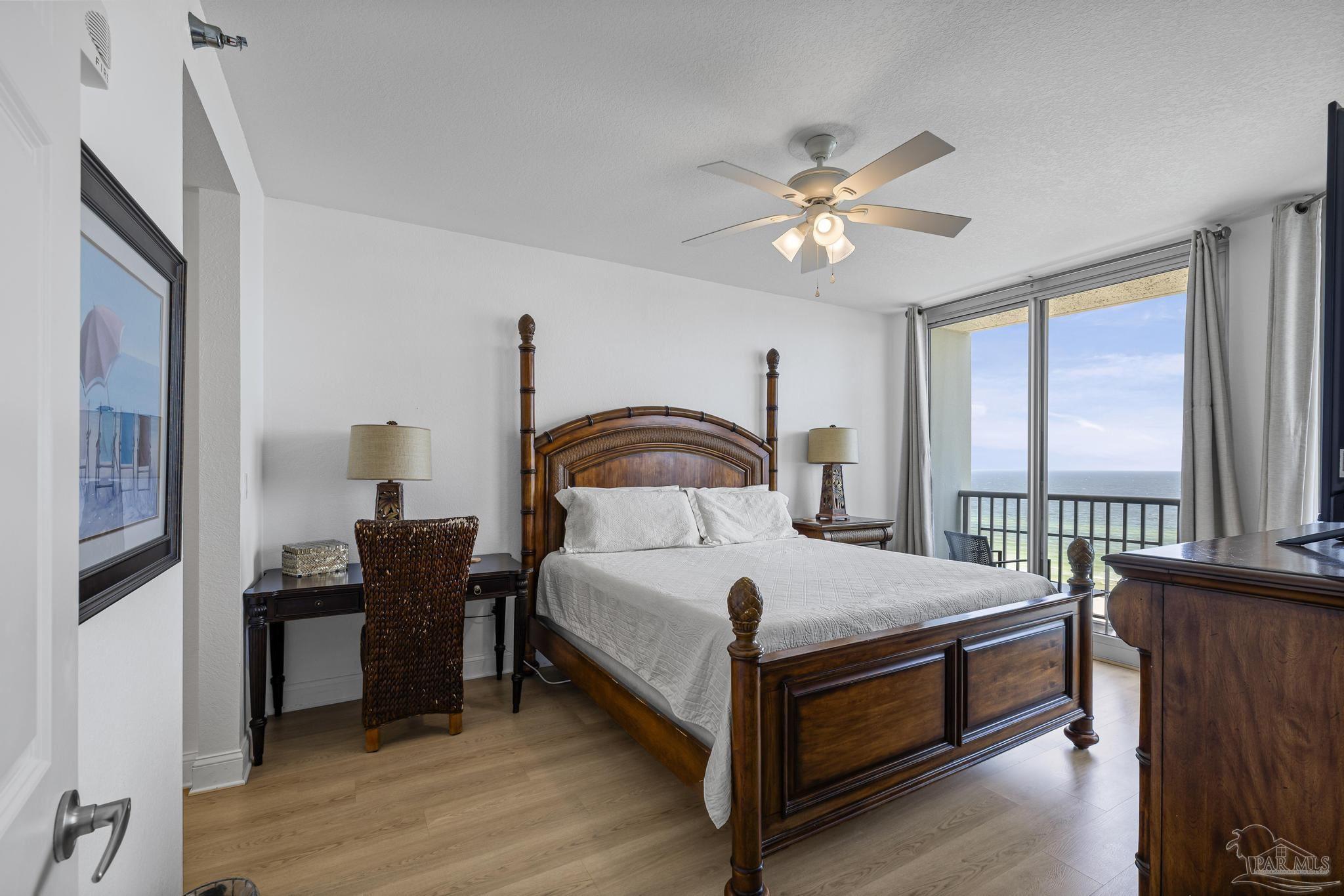 850 Fort Pickens Road, Unit 1230 Pensacola Beach, FL 32561 - Photo 25 of 67 a bedroom with a bed and a chandelier