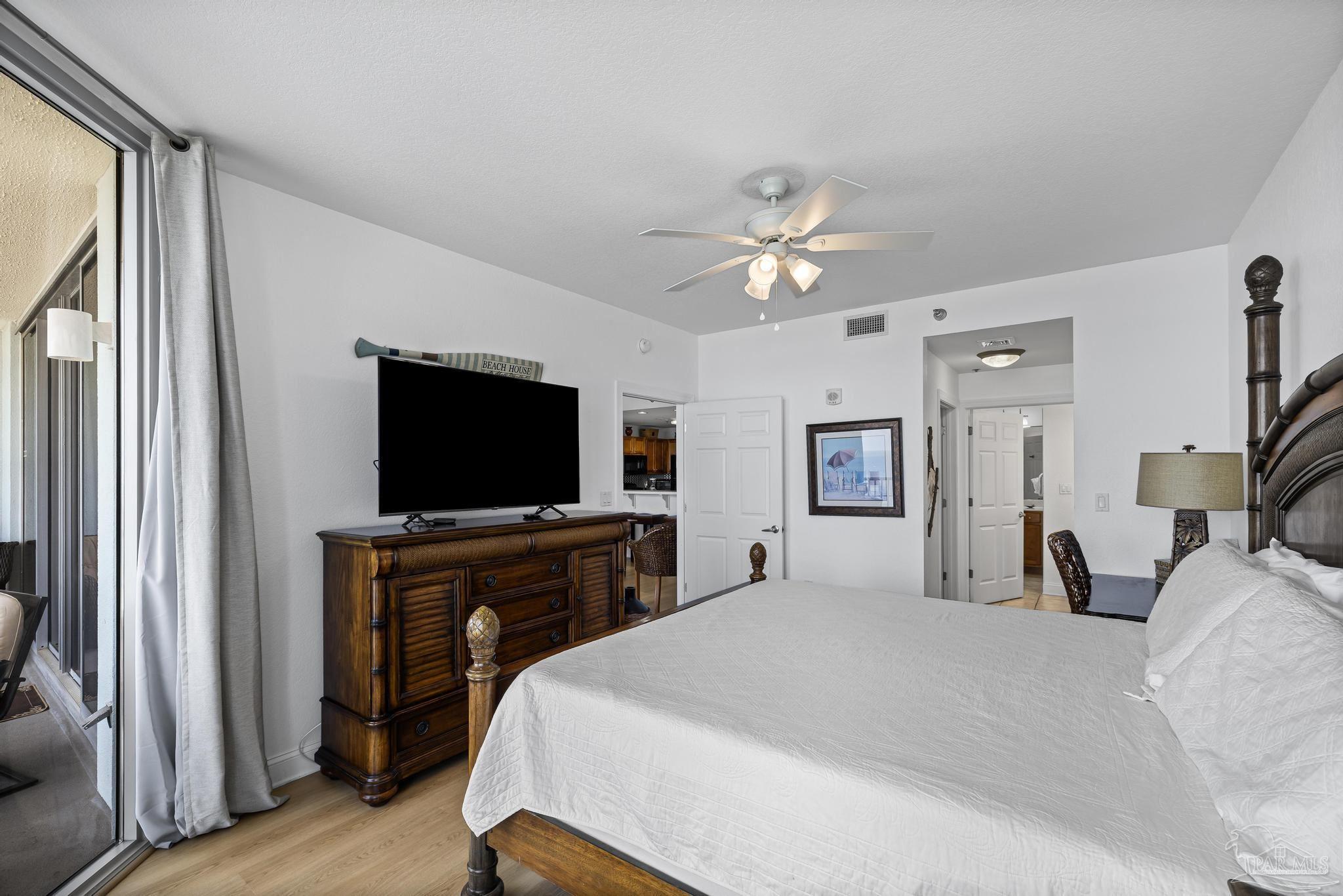 850 Fort Pickens Road, Unit 1230 Pensacola Beach, FL 32561 - Photo 27 of 67 a bedroom with a bed and a flat screen tv