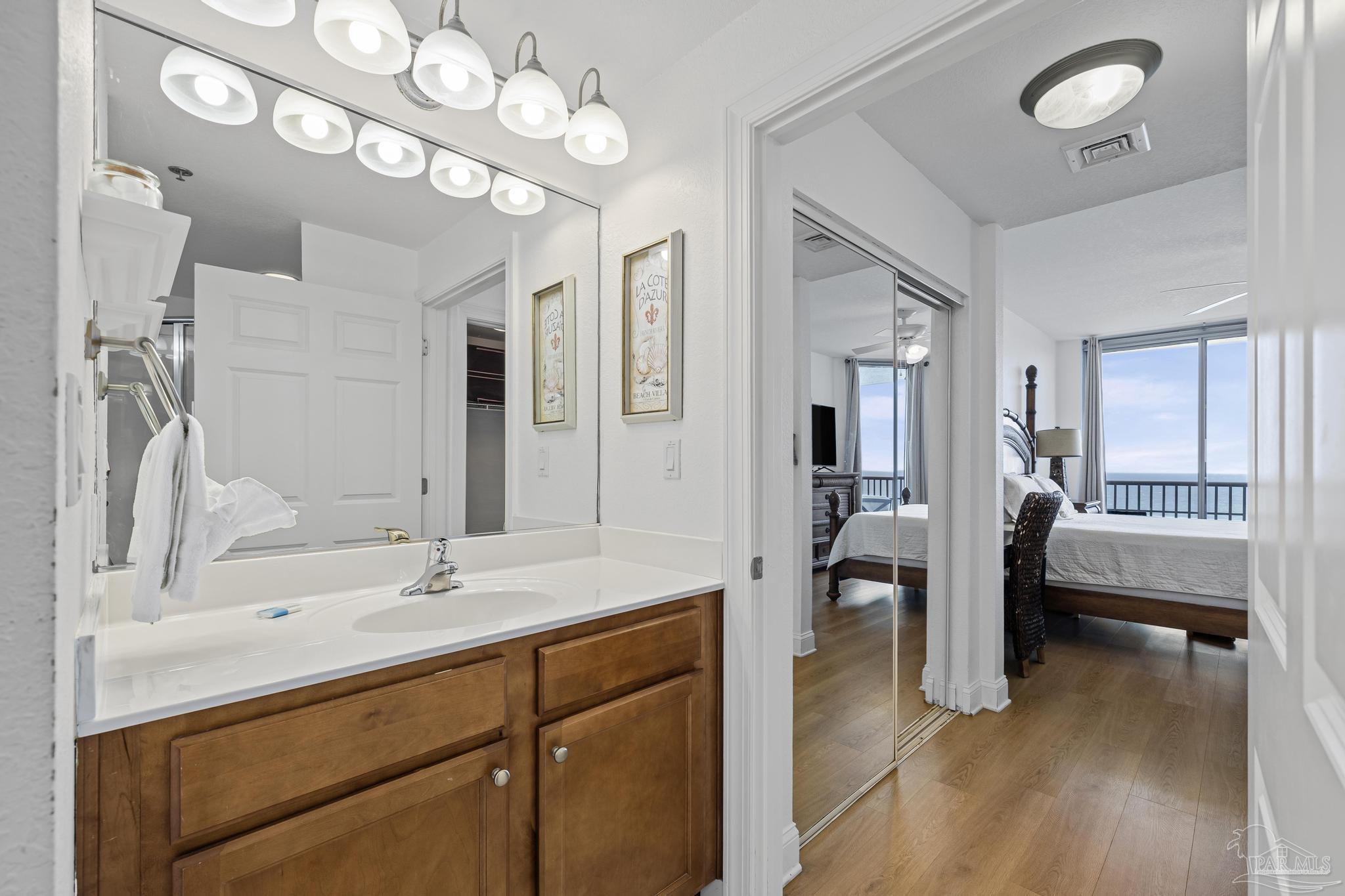 850 Fort Pickens Road, Unit 1230 Pensacola Beach, FL 32561 - Photo 29 of 67 a spacious bathroom with a double vanity sink a mirror and shower