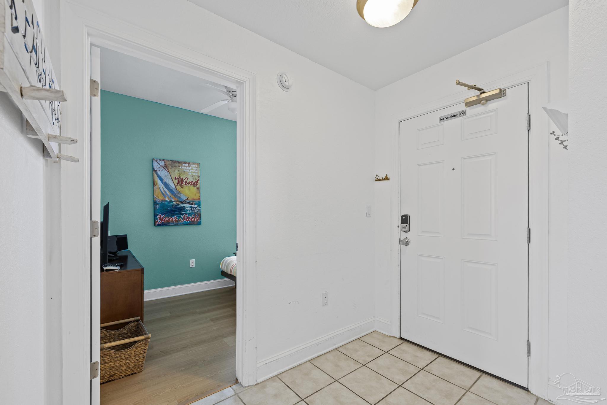850 Fort Pickens Road, Unit 1230 Pensacola Beach, FL 32561 - Photo 3 of 67 a view of a hallway with wooden floor and closet