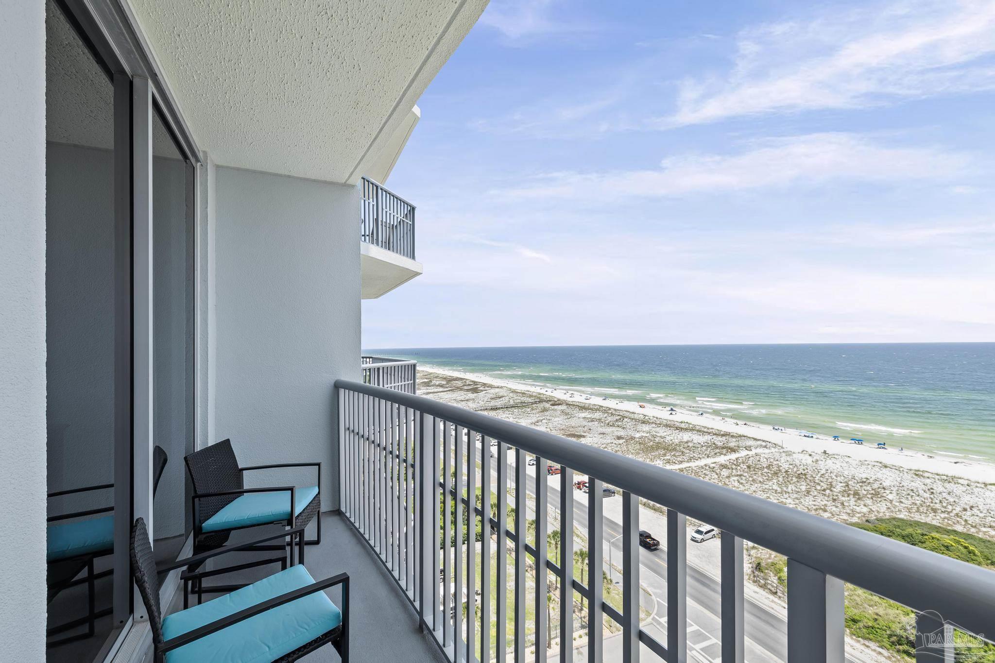850 Fort Pickens Road, Unit 1230 Pensacola Beach, FL 32561 - Photo 32 of 67 a view of a balcony with chair and wooden floor