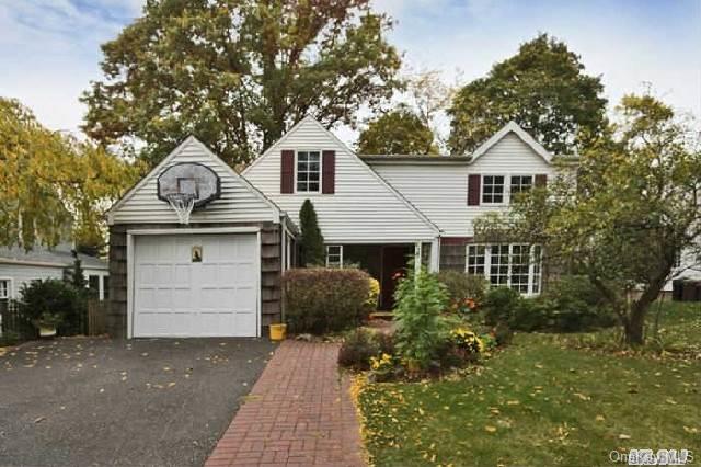 27 Derby Road Port Washington, NY 11050 - Photo 1 of 1 a front view of a house with a yard and garage