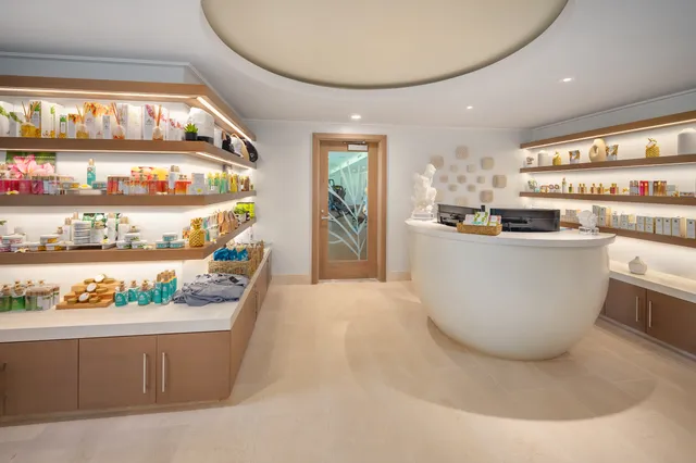 a living room with stainless steel appliances a dining table with kitchen island