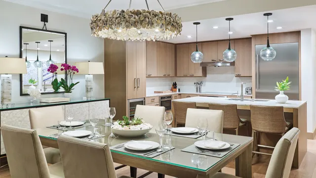 a dining room filled chandelier and kitchen view
