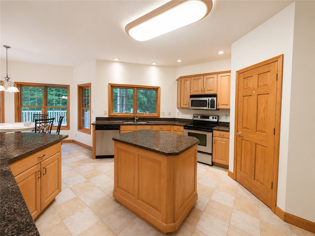 59 Kickapoo Valley Drive Charleston, IL 61920 - Photo 7 of 46 a kitchen with kitchen island granite countertop a sink counter top space appliances and a center island