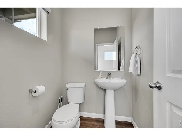 a bathroom with a sink toilet and a mirror
