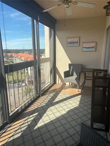 a view of a chairs and table in patio with a barbeque grill