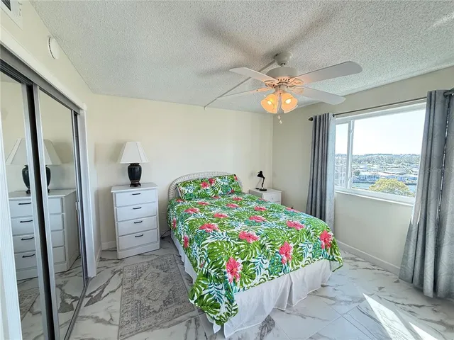 a view of a bedroom with furniture and flat screen tv