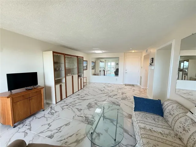 a large bedroom with a large bed and a flat screen tv