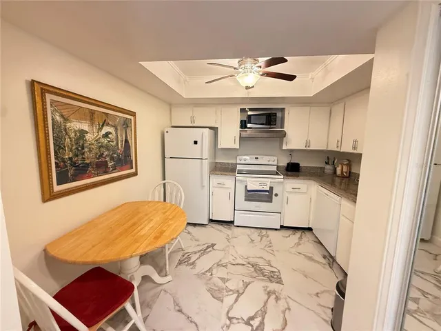 a kitchen with a refrigerator cabinets and a stove top oven