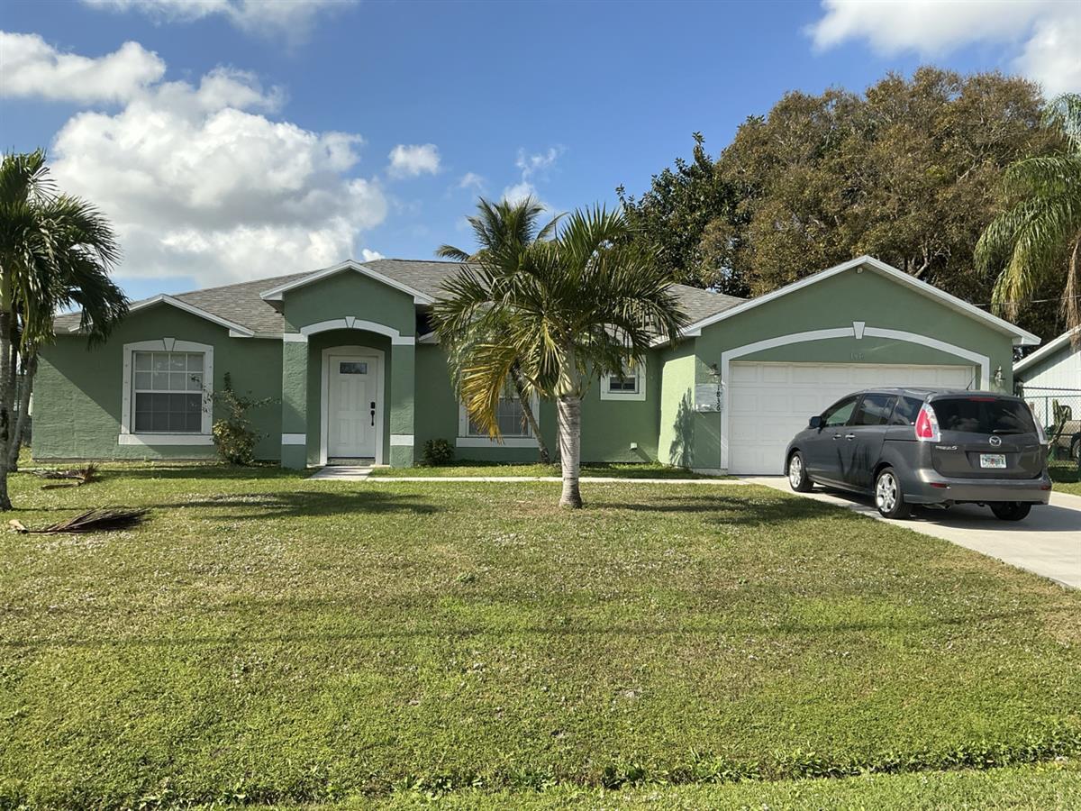 1836 Southeast Fallon Drive Port St. Lucie, FL 34983 - Photo 1 of 3 a front view of a house with garden