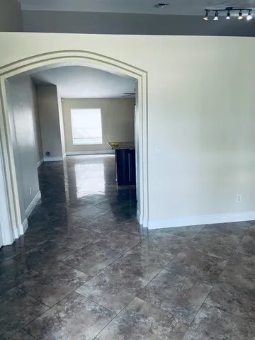 a view of a hallway with wooden floor and stairs