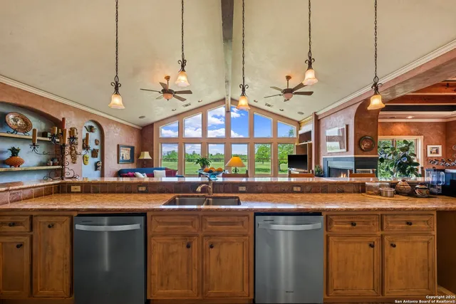 a kitchen with a sink and a large window