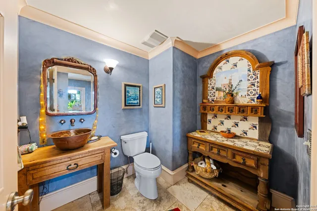 a bathroom with a toilet a sink and a mirror