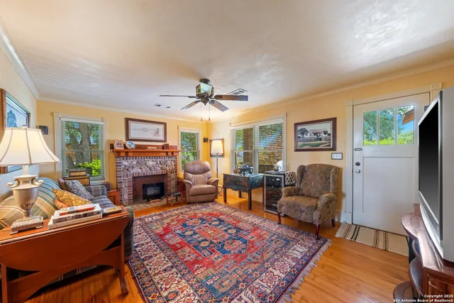 a living room with furniture flat screen tv and a fireplace