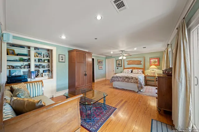 a bedroom with furniture and a book shelf