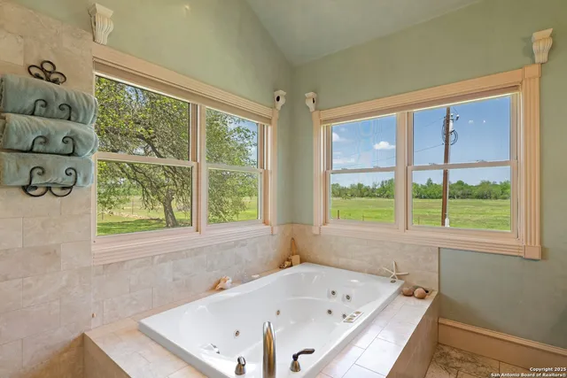 a bathroom with a bathtub and a window