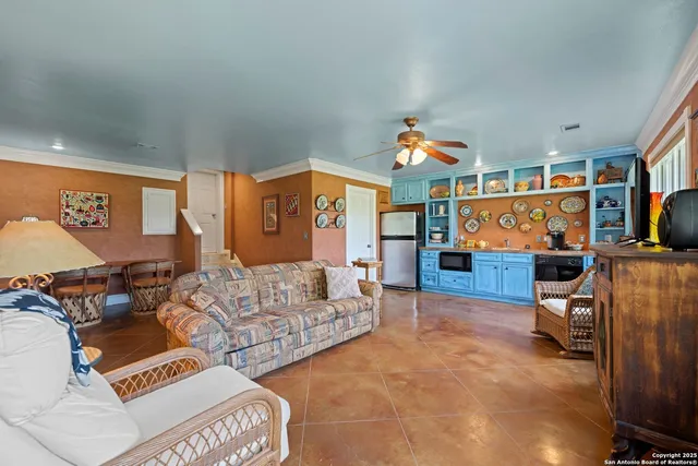 a living room with furniture a rug and a window