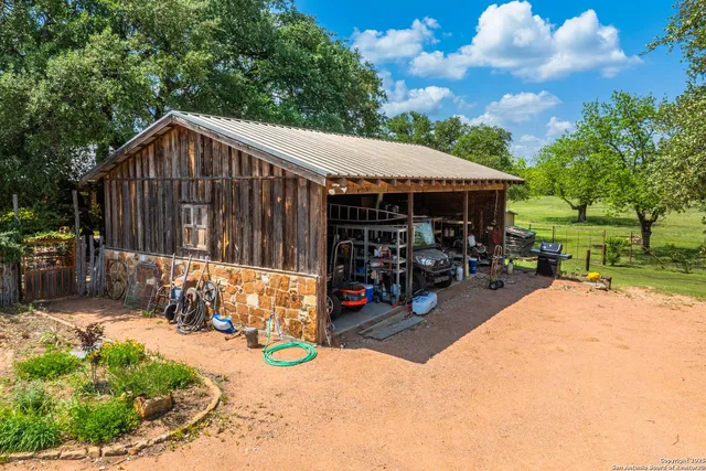 a view of a patio with a table chairs and a small yard