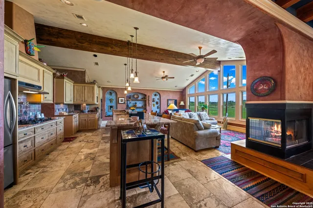 a living room with fireplace furniture and a wooden floor