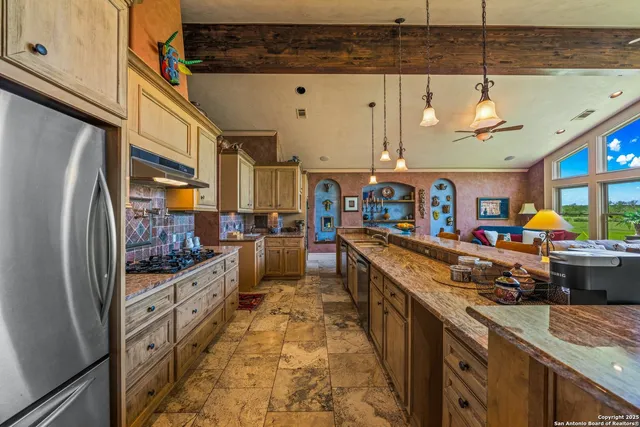 a kitchen with stainless steel appliances granite countertop a sink and stove